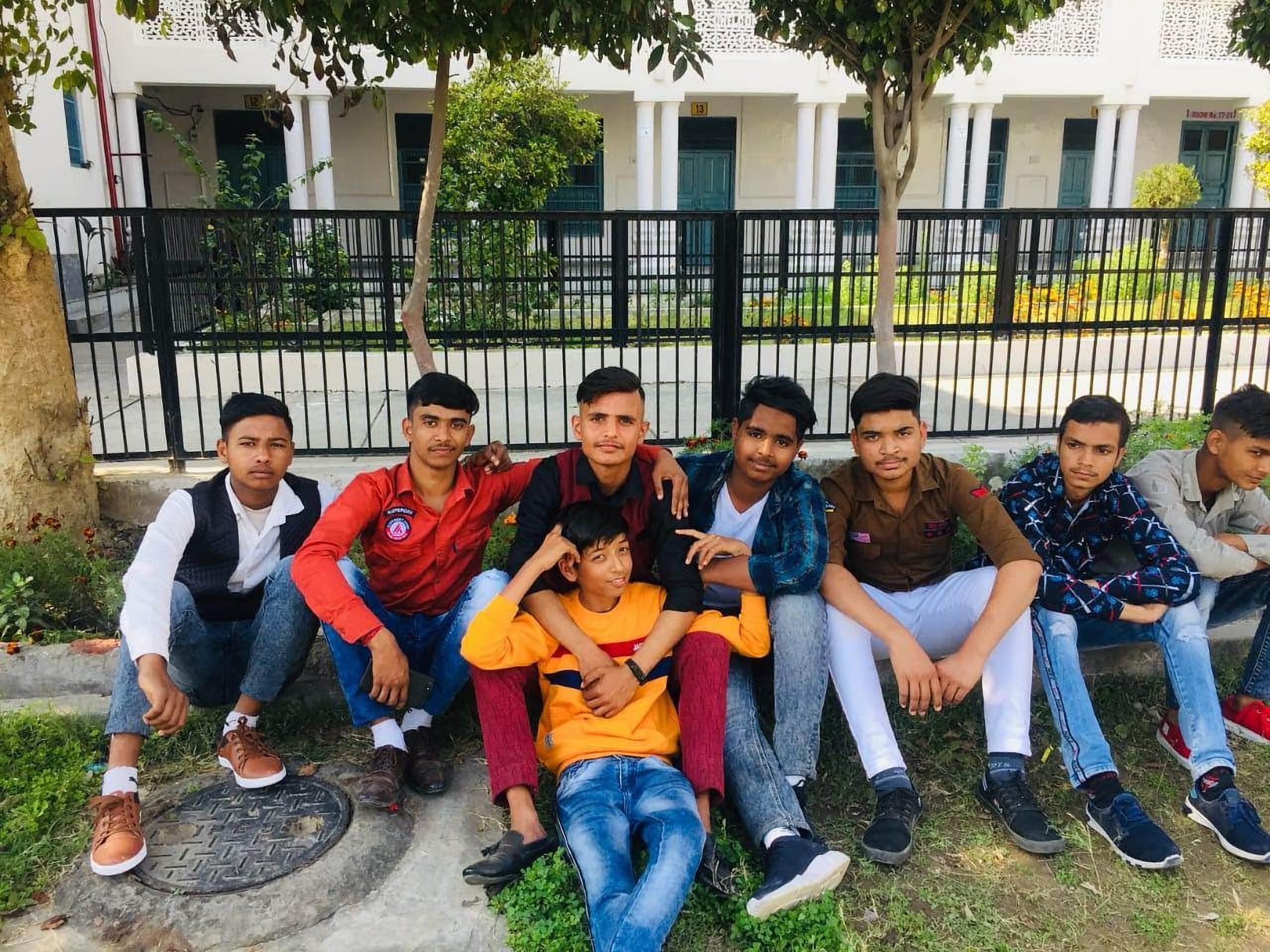 Students of D.A.V. School sitting together outside the academic block